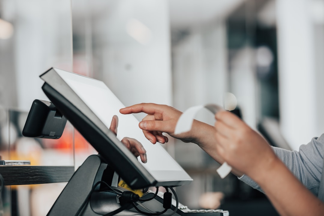 komise-schvalila-prevzeti-ingenica-allianzem a person is using a pos machine in a store